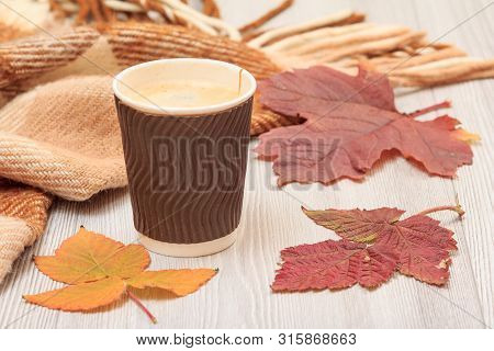 Cup Of Coffee, Dry Leaves And A Plaid In An Autumn Still Llife.