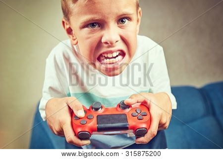 Hands using video game controller, on the couch at home