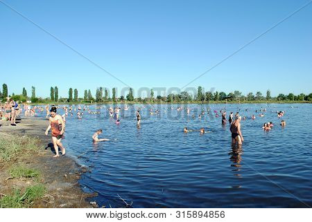 People Bathe In A Salt Lake At A Balneological Resort In Slavyansk Near Donetsk, Ukraine, June 15, 2