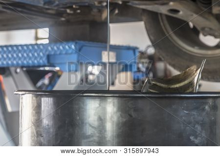 Drain The Old Oil From The Engine In Car Service Worksop