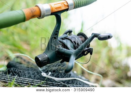 Fishing Reel, Catching Fish On A River
