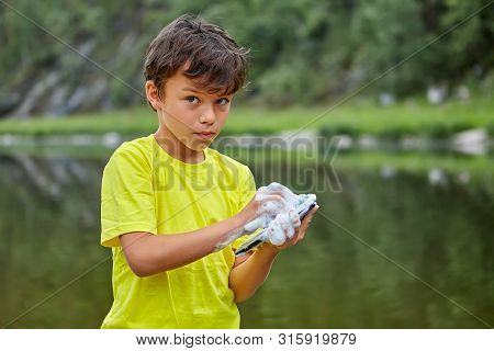 Young Vandal Washes A Parent Smartphone.