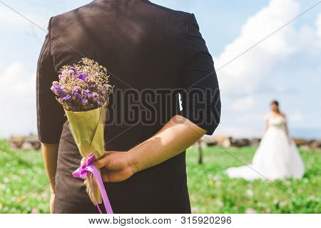 Beautiful Weding Bouquet In The Hands Of The Groom With Bride In A White Wedding Dress. Wedding Cere