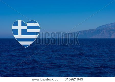Heart Shaped Greek Flag On Background Made Of Seascape With Mountains And Deep Blue Mediterranian Se