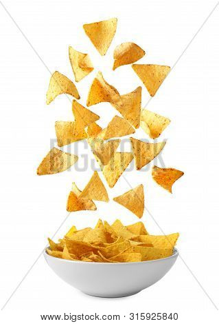 Delicious Mexican Nachos Chips Falling Into Bowl On White Background