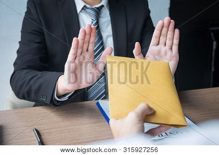 Anti Bribery And Corruption Concept, Business Man Refusing And Don't Receive Money Banknote In Envel