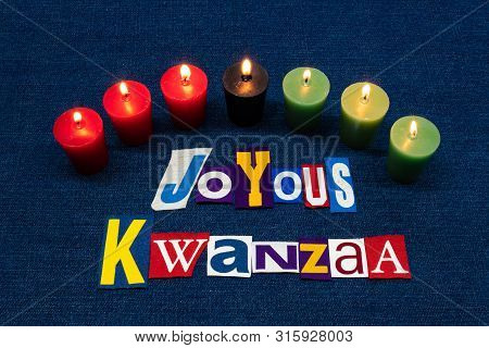 Joyous Kwanzaa Word Text Collage Typography, Seven Candles And Multi Colored Fabric On Blue Denim, A