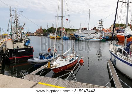 Ustka, Pomeranian / Poland - August 7, 2019: View Of The Fishing Port On The Baltic Sea. Harbor Buil