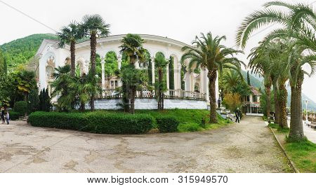 Gagra, Abkhazia - 02 May 2019: White Arches Of The Colonnade On Ardzinba Avenue Of The Resort Town. 