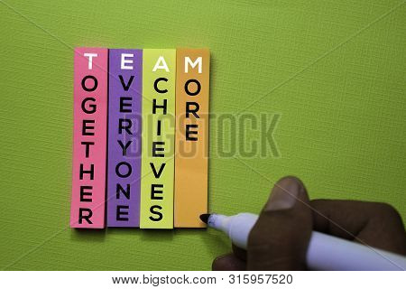 Together, Everyone, Achieves, More (team) Text On Sticky Notes Isolated On Green Desk. Mechanism Str