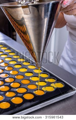 Pastry Chef In The Kitchen Makes Passion Fruit Confit. Cook Pours Passion Fruit Confit Into The Mold