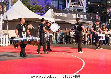 LOS ANGELES, CA, USA - AUGUST 2, 2019: Downtown Dark Nights Event at L.A. LIVE in the Xbox Plaza, next to the Staples Center. A drumline live performance in front of a crowd. A night full of music, live art, live performances, shopping, and dining.