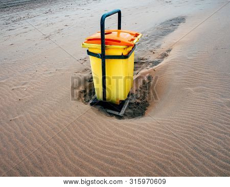 Modern Yellow Garbage Bin Waste Collection On The Sand Beach In Netherlands In The Overveen Beach