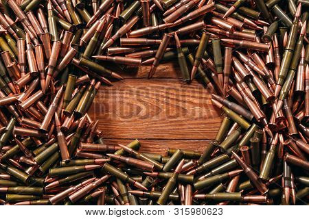 Different Ammo On Wooden Background, Weapon Concept.