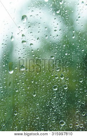 Water Drops On Glass On Spring Rainy Day.