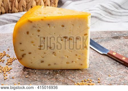 Cheese Collection, Piece Of Hard Yellow Dutch Gouda Cheese With Dried Fenugreek Seeds
