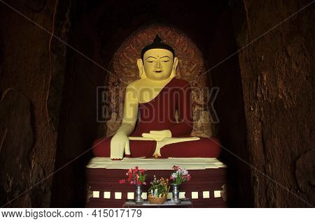 Bagan, Myanmar - November 18, 2015: Huge Colored Statue Of Buddha In Temple, From Below Shot Of Colo