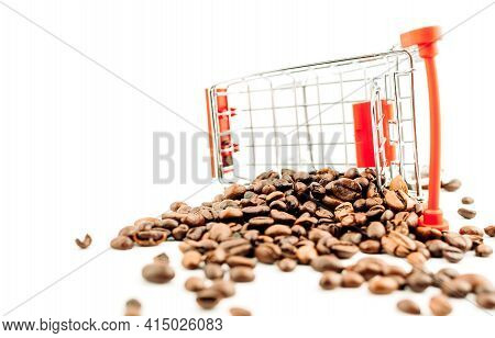 Shopping Cart With Coffee Beans On A White Background. The Beans Cart Overturned And Spilled The Cof