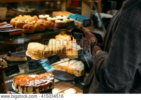 Confectionery Customer, Client In Sweet-shop, Pastry-shop. Back View Of Young Woman Choosing Cake De