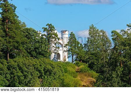White Turrets Of The Chapel In Ludwigsburg Park Mon Repos In Vyborg On The Background Of Blue Sky.