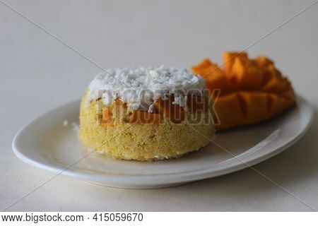 Steamed Ground Rice, Layered With Coconut Shavings And Mango. Locally Known As Mango Puttu. A Tradit