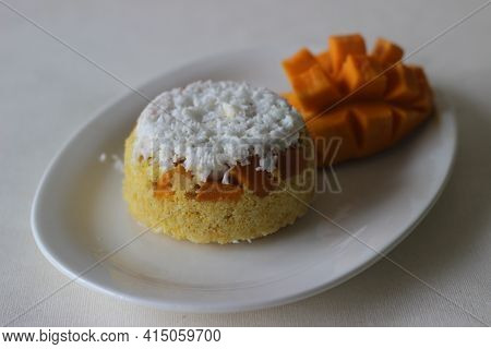Steamed Ground Rice, Layered With Coconut Shavings And Mango. Locally Known As Mango Puttu. A Tradit