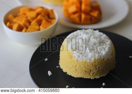 Steamed Ground Rice, Layered With Coconut Shavings And Mango. Locally Known As Mango Puttu. A Tradit
