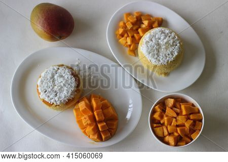 Steamed Ground Rice, Layered With Coconut Shavings And Mango. Locally Known As Mango Puttu. A Tradit