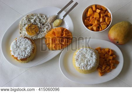 Steamed Ground Rice, Layered With Coconut Shavings And Mango. Locally Known As Mango Puttu. Served W