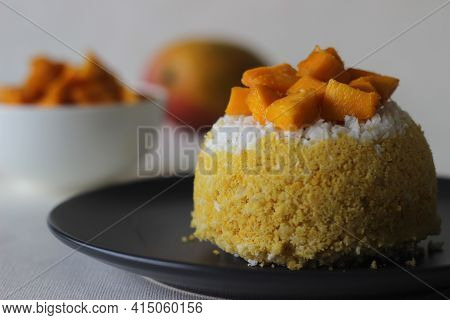 Steamed Ground Rice, Layered With Coconut Shavings And Mango. Locally Known As Mango Puttu. A Tradit