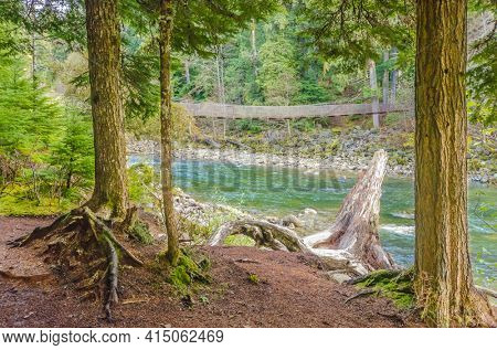 Beautiful Mountain River and suspention bridge at Cal Cheak Recreation Site, Sea-to-Sky Hwy, Whistler, Vancouver, Canada.