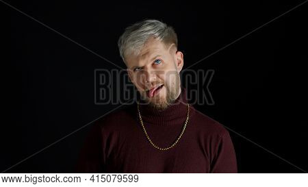 Comical Stupid Stylish Man With Blue Eyes In Trendy Clothes Making Funny Awkward Silly Face Grimace,