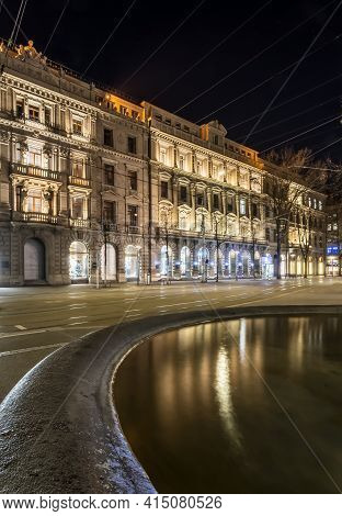 Historic Buildings And Reflection In A Water Of A Fountain On The Bahnhofstrasse In Zurich, Switzerl