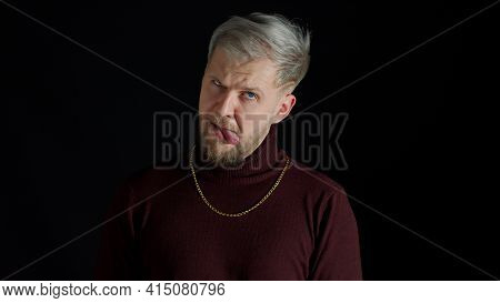 Stupid Comical Stylish Man With Blue Eyes In Trendy Clothes Making Funny Awkward Silly Face Grimace,