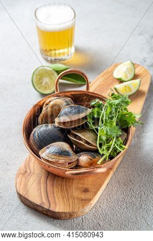 Raw Uncooked Clams Vongole Shells Shellfish With Ingredients For Cooking Coriandr, Beer And Lime In 
