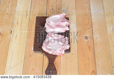 Salted And Peppery Steak Lies On A Wooden Stand