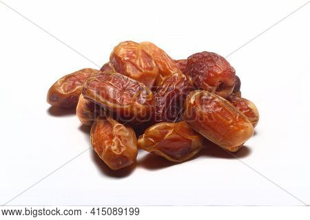 Dates On A White Background. Dried Fruits. Dried Dates Lie Next To Each Other