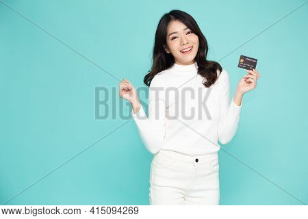 Young Beautiful Asian Woman Smiling, Showing, Presenting Credit Card For Making Payment Or Paying On