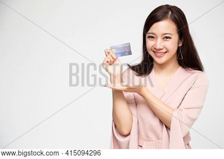 Young Beautiful Asian Woman Smiling, Showing, Presenting Credit Card For Making Payment Or Paying On