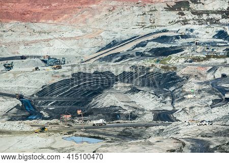 Mining Dump Trucks Working In Coalmine , Used As A Source Of Electricity Generation In The Country.
