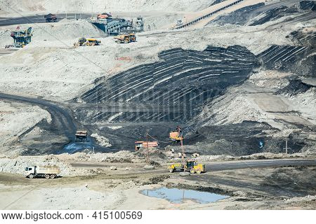 Mining Dump Trucks Working In Coalmine , Used As A Source Of Electricity Generation In The Country.