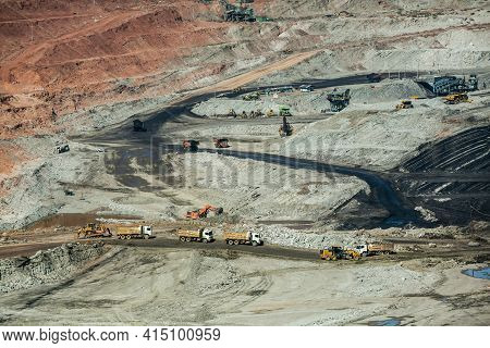 Mining Dump Trucks Working In Coalmine , Used As A Source Of Electricity Generation In The Country.