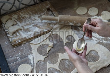 Process Of Stuffing Mashed Potato At A Round Rolled Piece, Woman Hands With Tea Spoon, Rolled Dough,