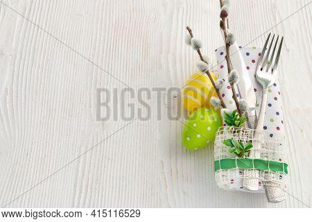 Sweet Easter Symbols Colored Yellow And Green Eggs On White Wooden Table.
Spring Table Setting With 