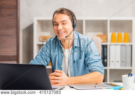 Workplace Of Freelance Worker Or Sudent At Home Office. Young Man Works Using Computer And Other Dev