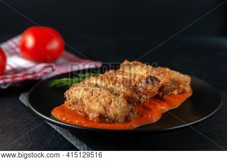 Buffolo Wings Close-up In Ceramic Bowl With Tomato Sauce And Tomatoes