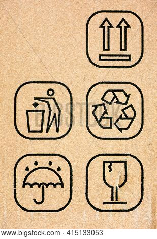 Five Symbol On Cardboard Box - This Way Up, Do Not Litter, Recycling, Keep Dry And Fragile. Close-up