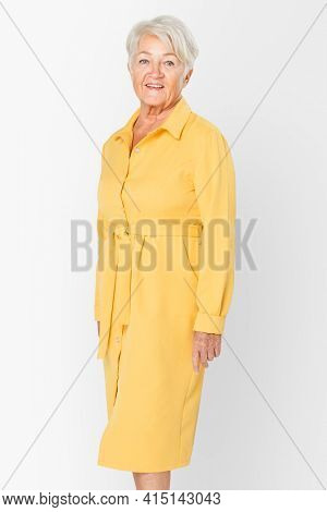 Senior woman in yellow shirt dress apparel with design space