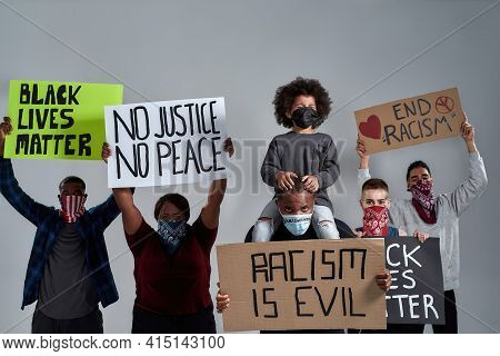 Young Multiracial People And African American Kid Holding Anti Racist Posters And Wearing Buffs Stan