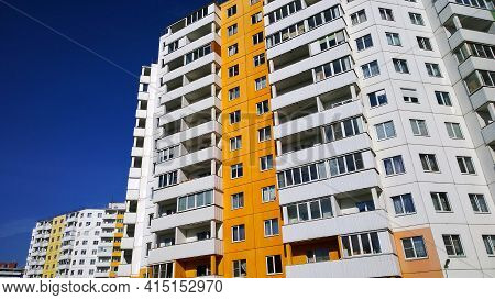 Facade Of New Multicolor Residential Building. Rising Prices For Purchase, Sale And Rental Of Real E